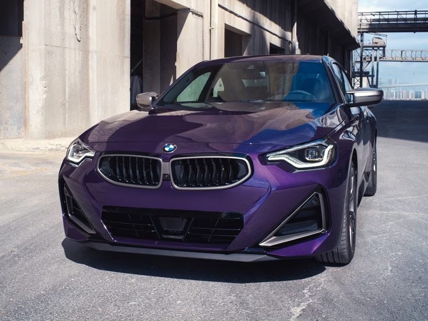 The 2024 BMW M240i in Thundernight Metallic at a three-quarter front view.