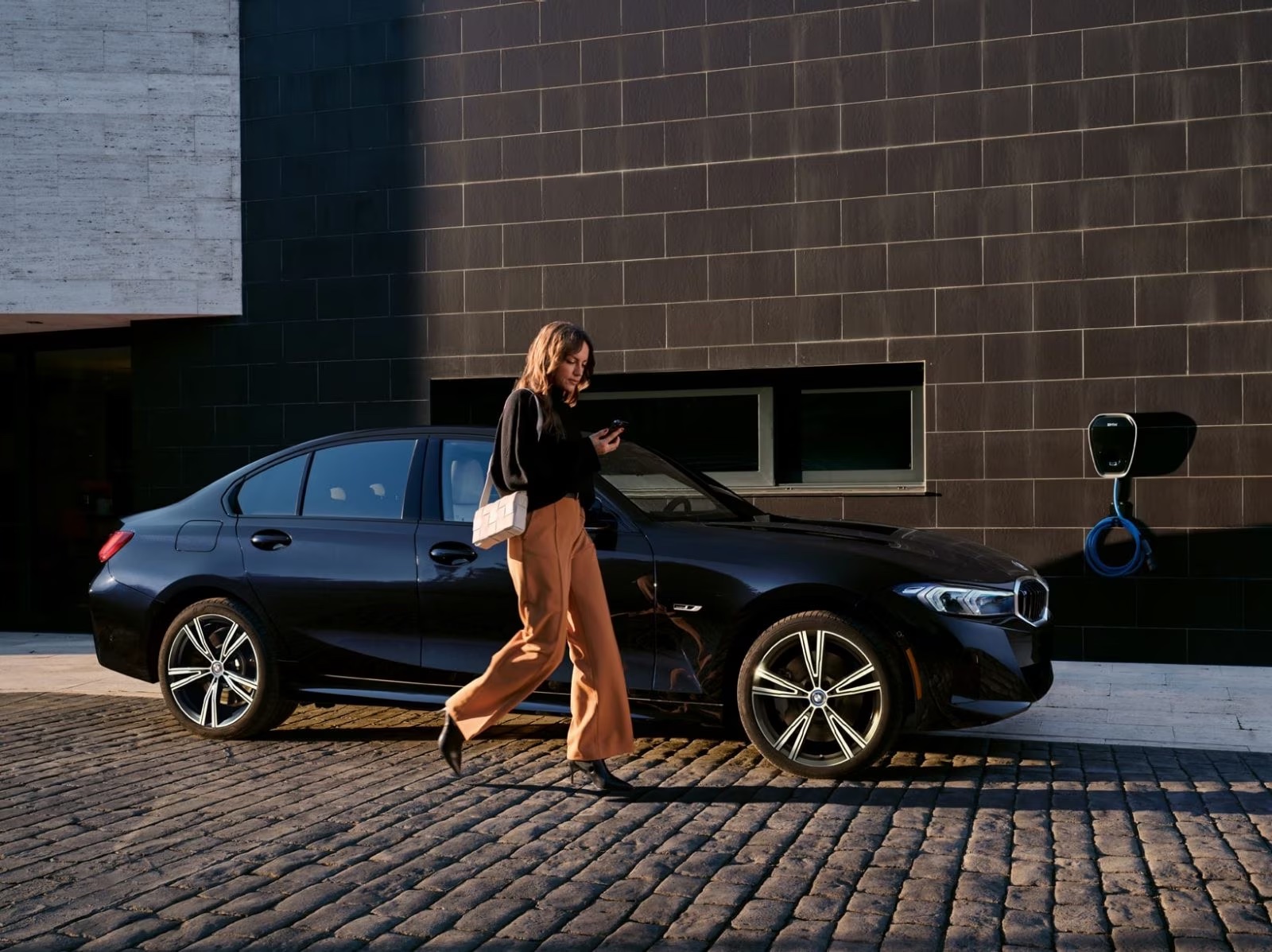 Woman walking in front of the 2024 BMW 3 Series