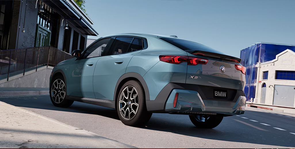A blue 2026 BMW X2 driving in IL